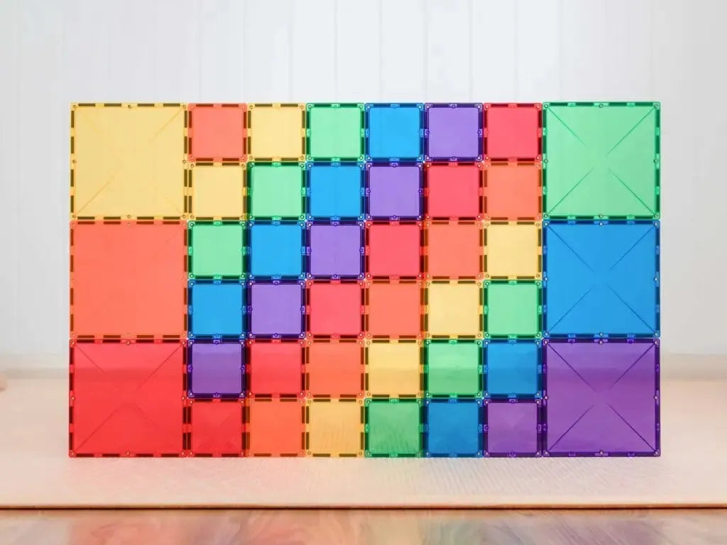 Colorful magnetic building tiles arranged in a rectangular pattern.