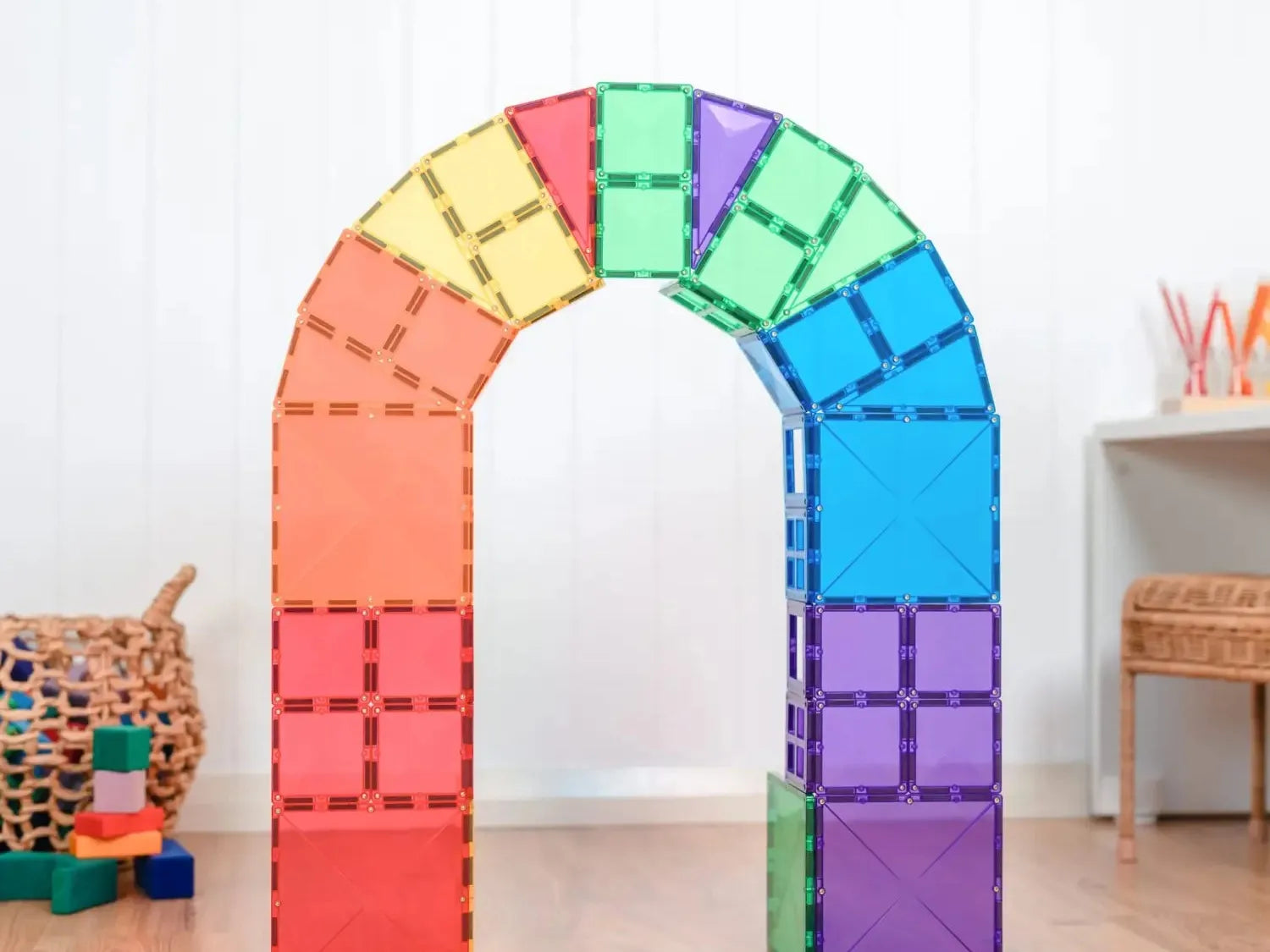 Colorful rainbow-shaped arch made of magnetic building tiles.