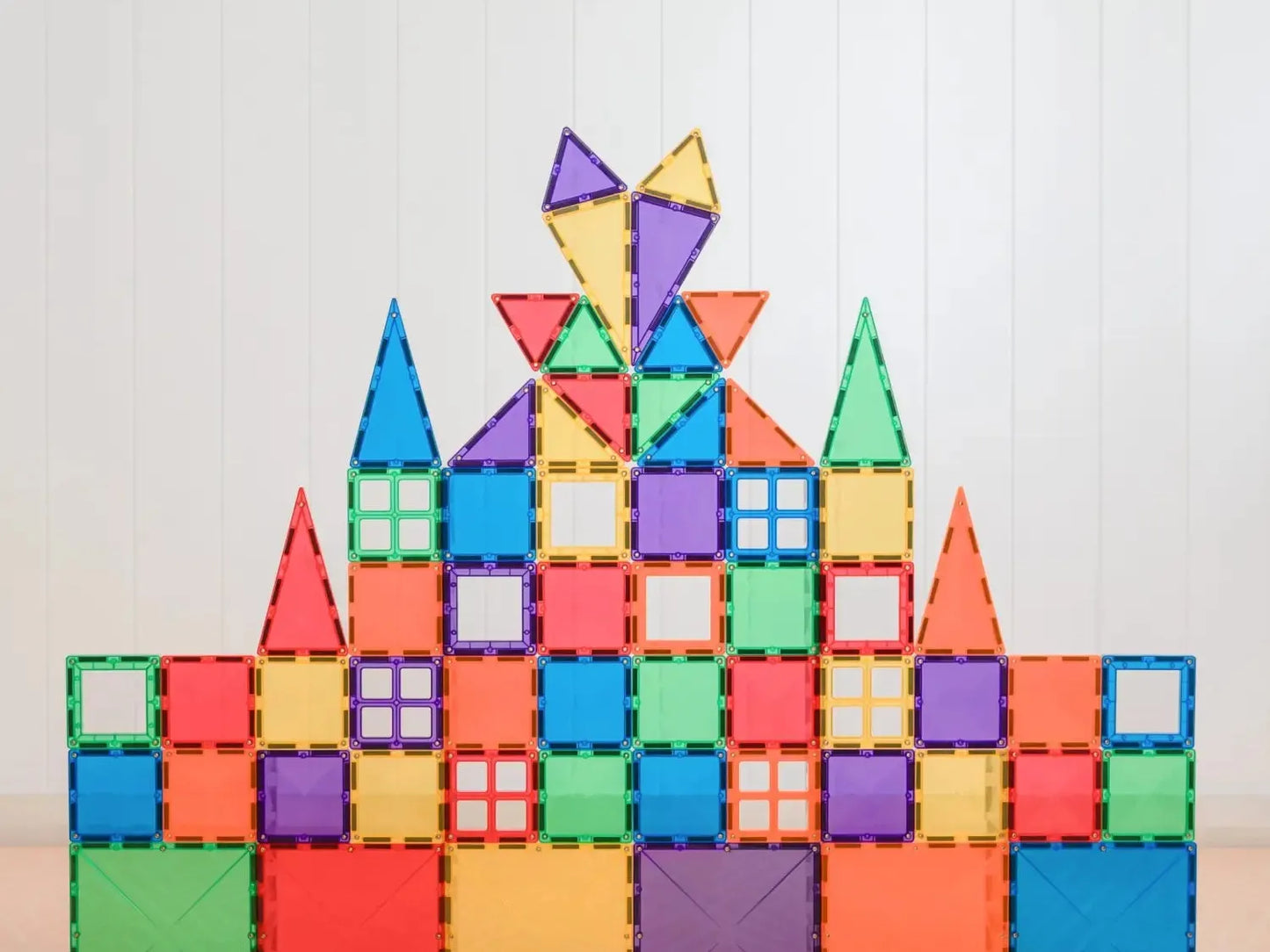Colorful geometric building blocks stacked in a pyramid-like structure.