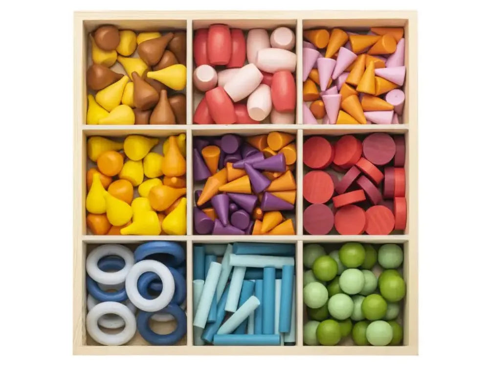 Wooden compartmentalized box filled with colorful geometric wooden shapes.