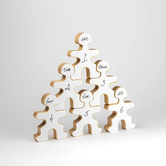 Pyramid-shaped stack of numbered wooden human figure cutouts.