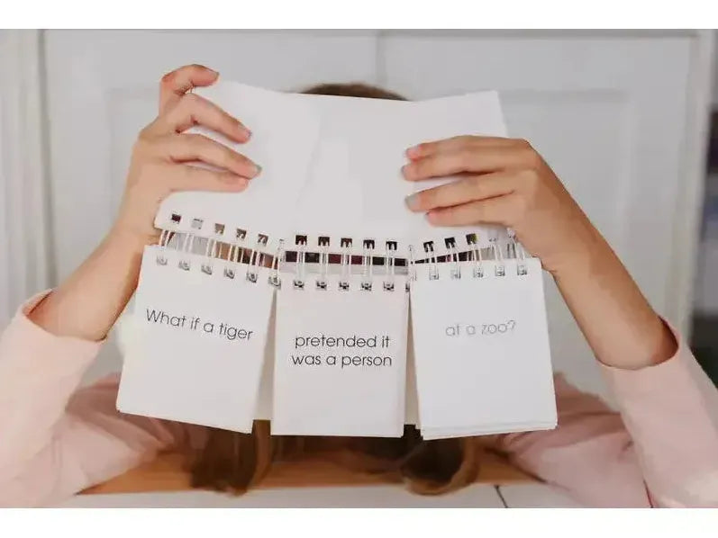 Spiral-bound notepad with three visible pages containing handwritten text.