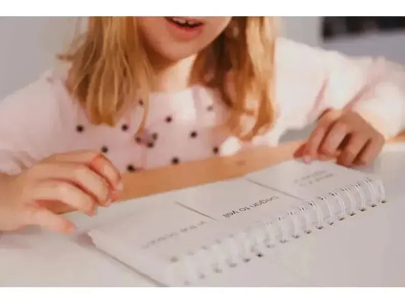 Spiral-bound notebook or planner open on a surface.