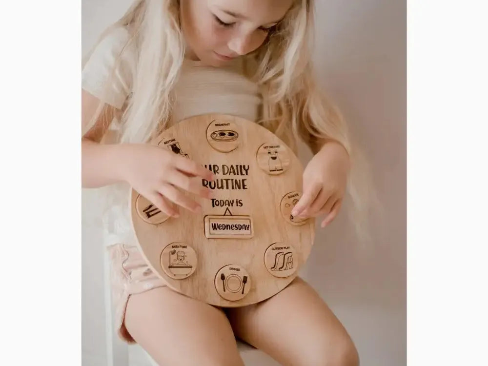 Wooden circular board with daily routine activities illustrated and labeled.