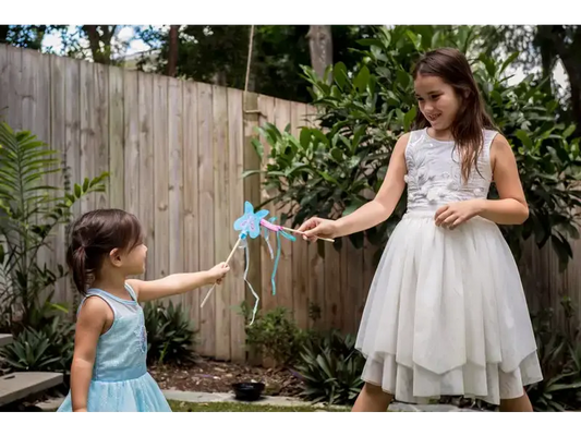 Two girls playing with a wand.