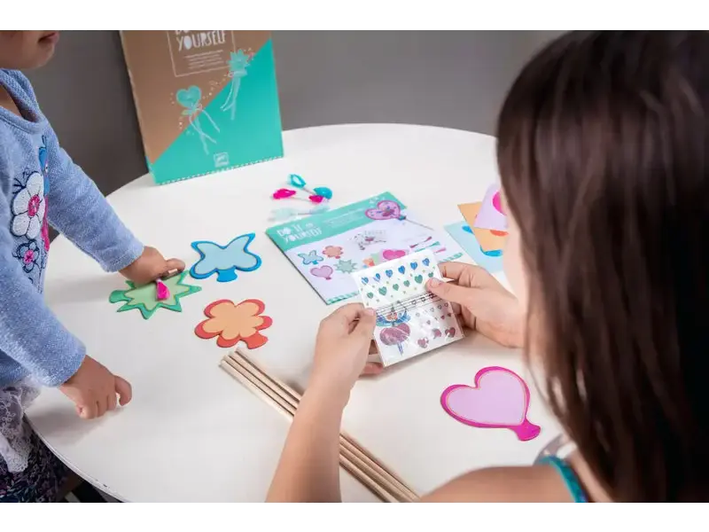 Crafting activity with stickers and shapes.