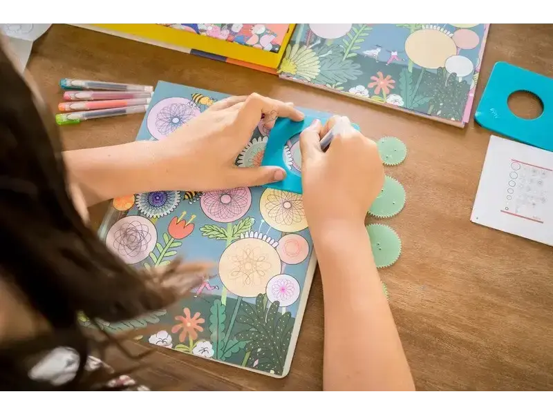 Colorful floral notebook or journal being written in with a pen.