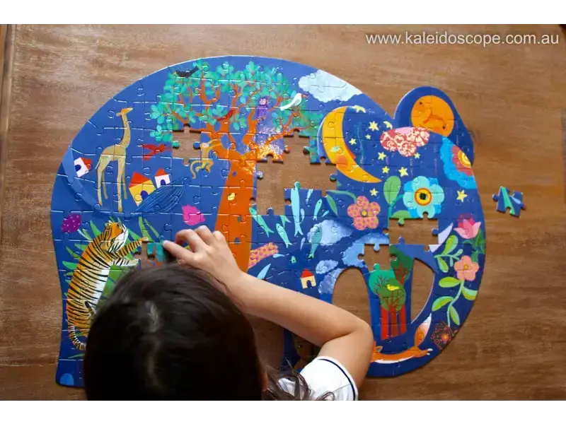 Colorful elephant-shaped jigsaw puzzle with whimsical nature and animal designs being assembled.