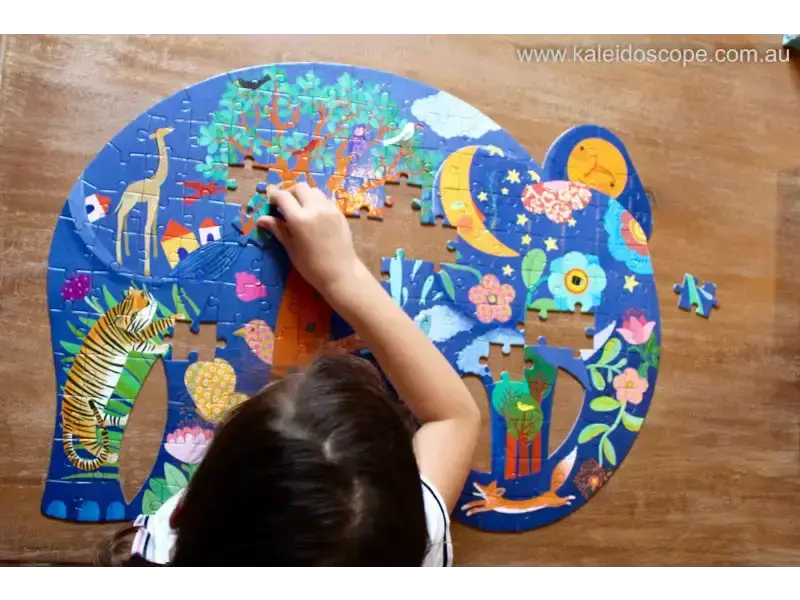 Colorful elephant-shaped jigsaw puzzle being assembled on a wooden surface.