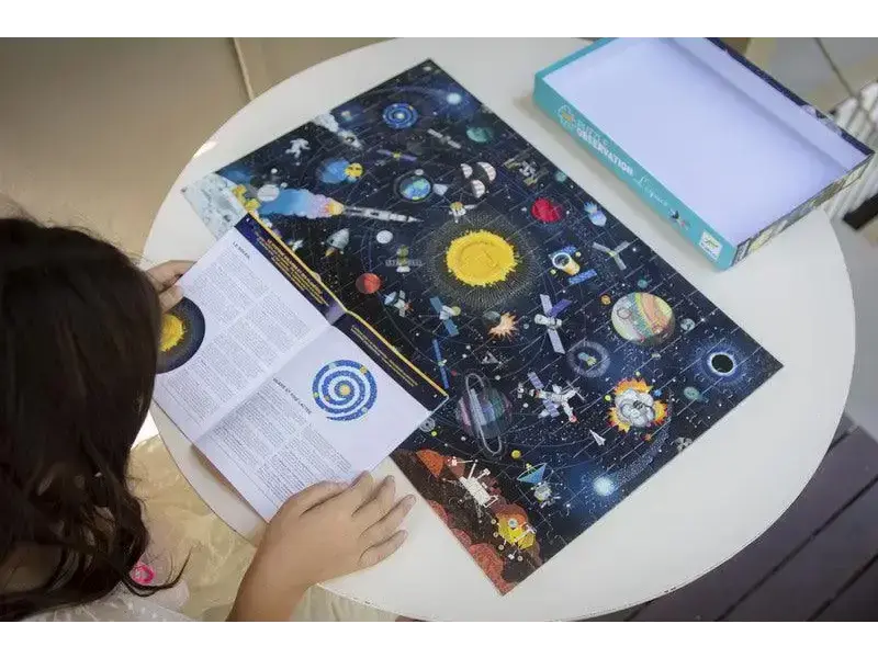 Space-themed notebook or journal with colorful celestial illustrations on its cover.