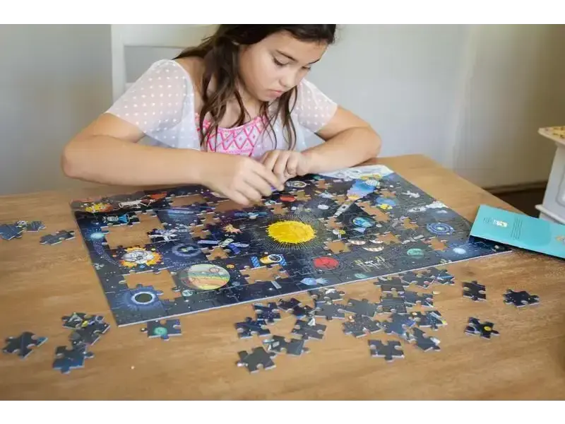 Puzzle depicting the solar system with planets and space objects.