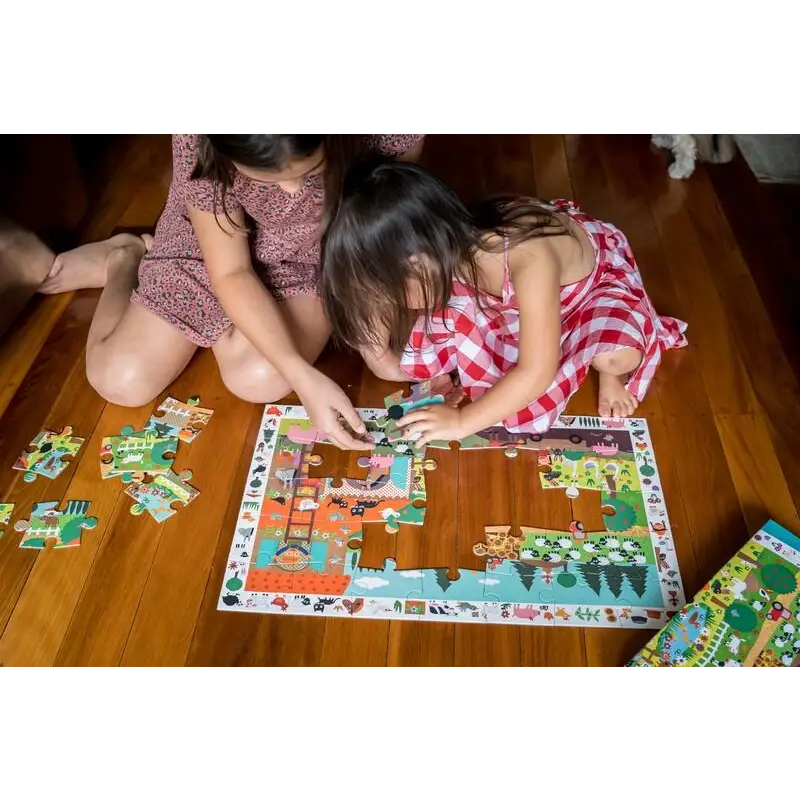 Puzzle being assembled by children on a wooden floor.