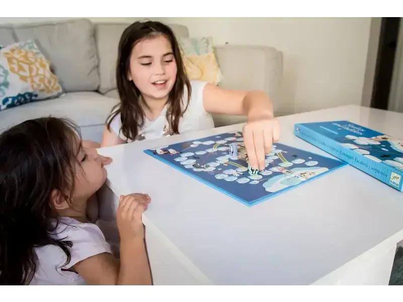 Board game being played by two children on a table.