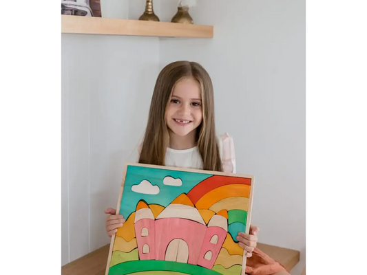 Colorful painting of a whimsical castle with a rainbow and clouds.