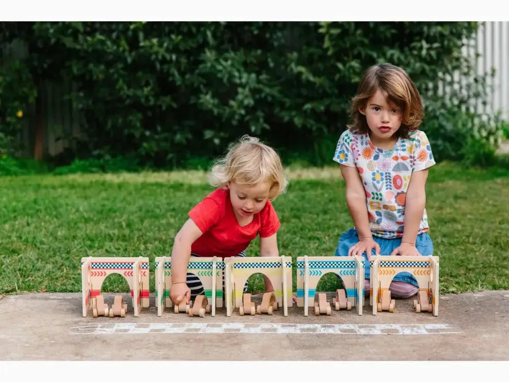 Wooden toy train set with arched windows and doors.