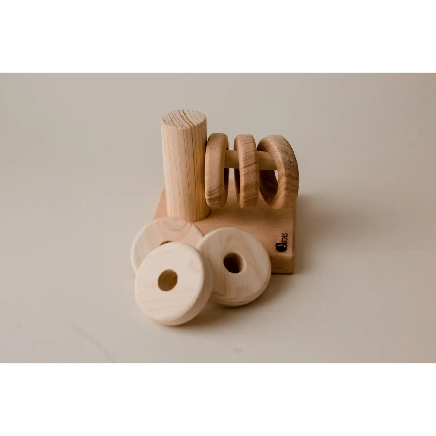 Wooden napkin holder with circular napkin rings.