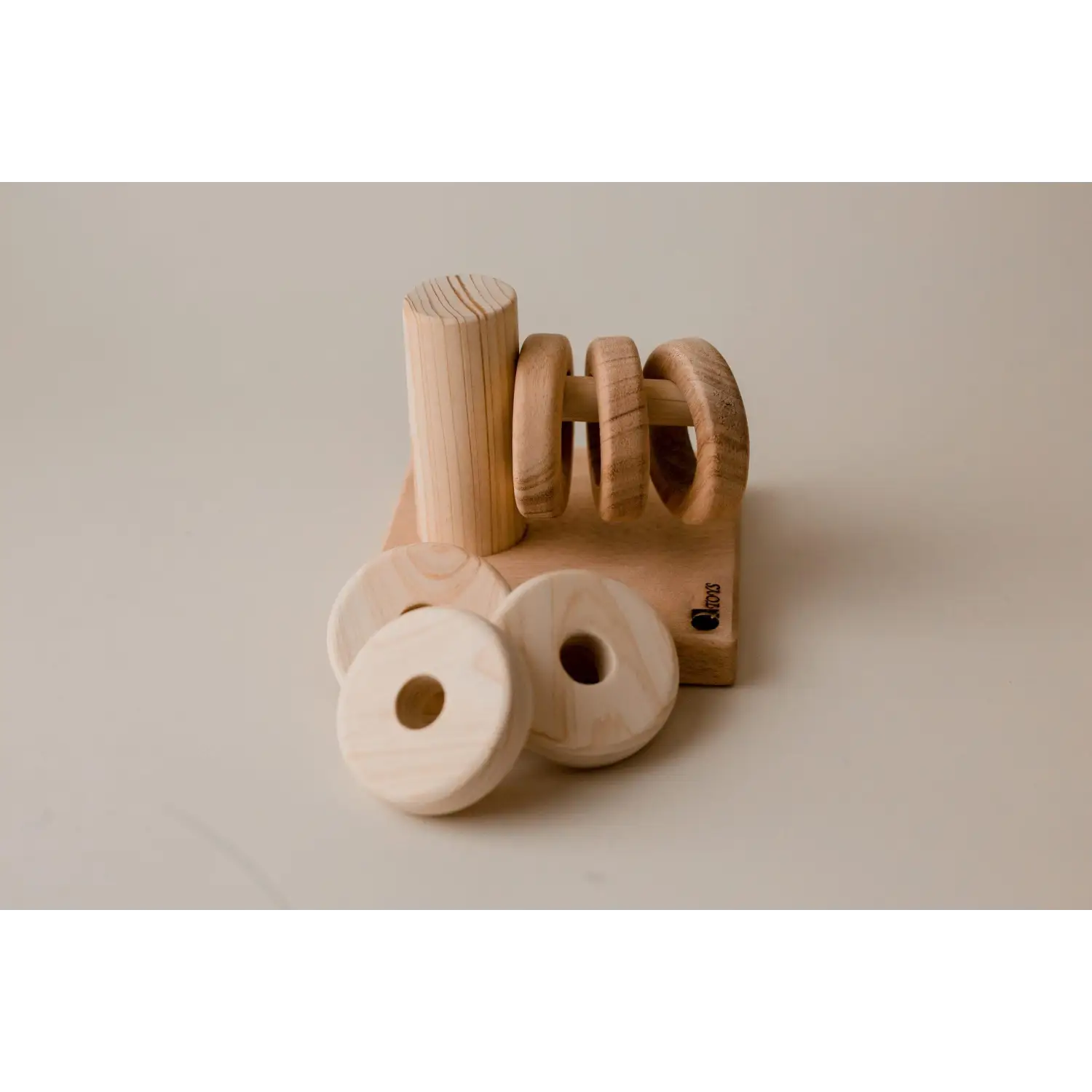 Wooden napkin holder with circular napkin rings.