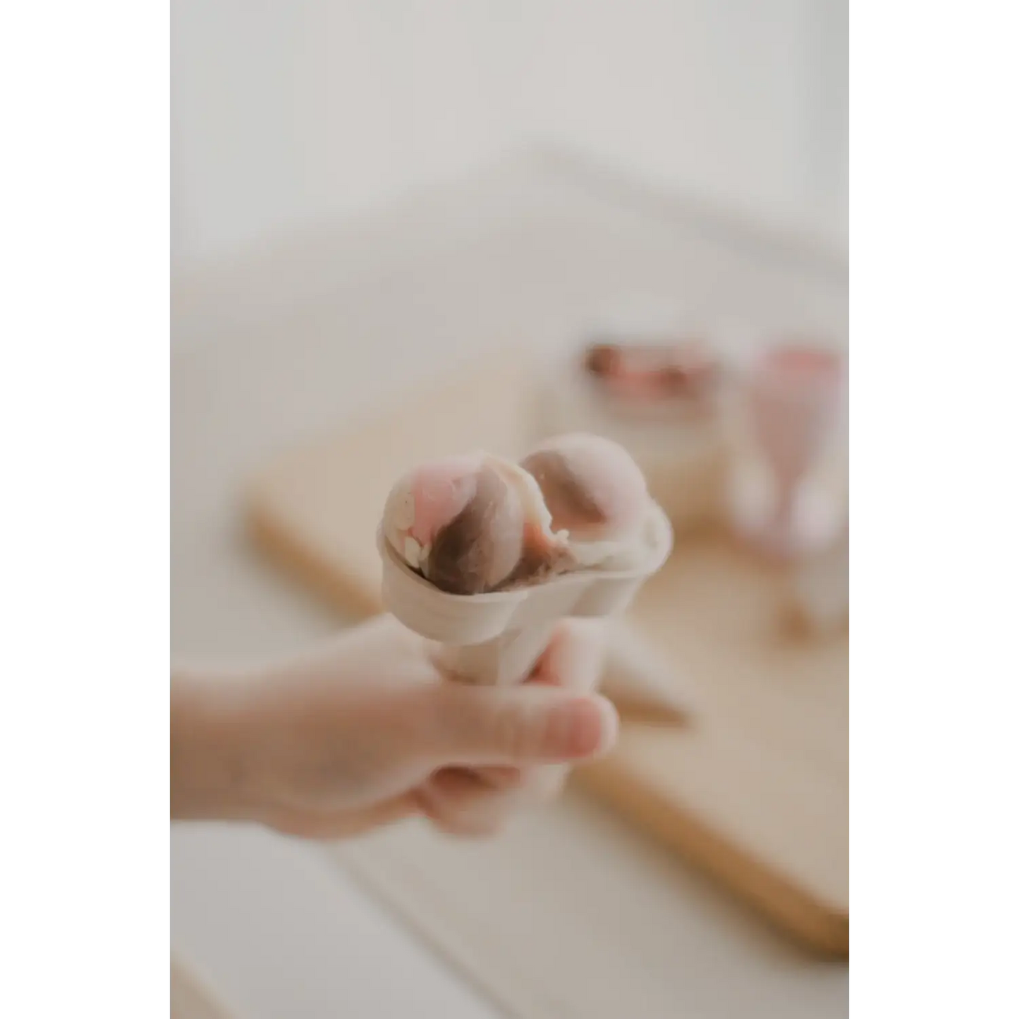 Ice cream cone held in a hand.