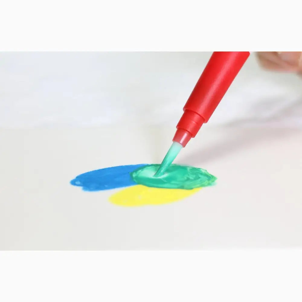 Red marker pen mixing paint colors on a surface.