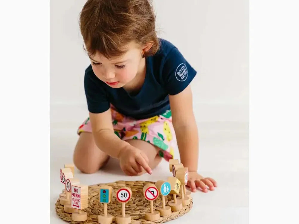 Wooden circular toy with colorful pegs and traffic signs.
