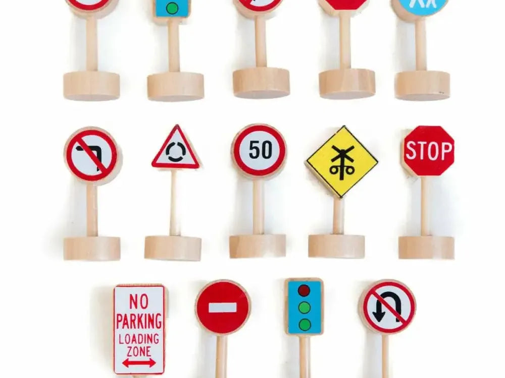 Collection of miniature wooden traffic signs and road signs.