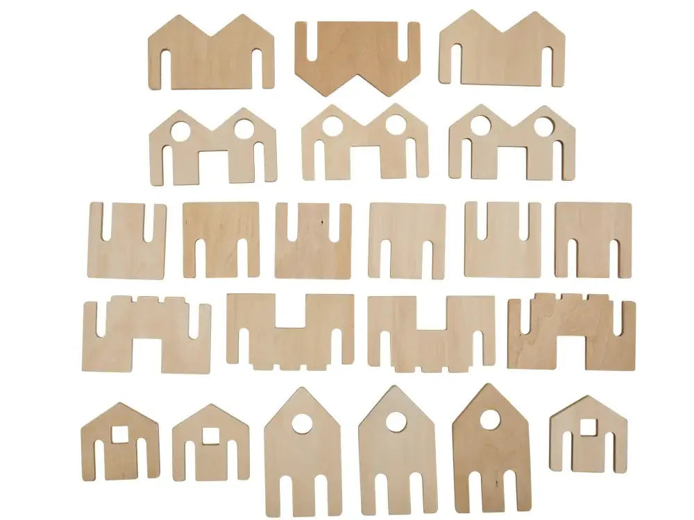 Collection of wooden or cardboard cutouts in various geometric shapes resembling simplified house or building forms.