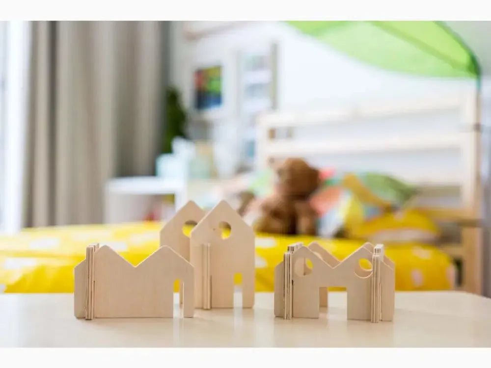 Wooden building blocks shaped like simple houses or structures.