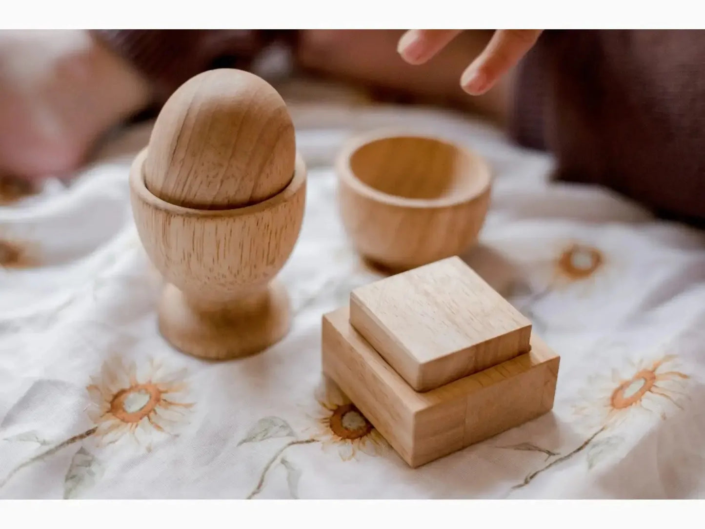 Wooden egg cup with accompanying small wooden boxes or containers.