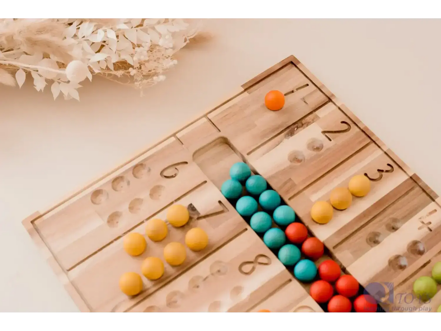 Wooden counting board with colorful beads arranged in rows.