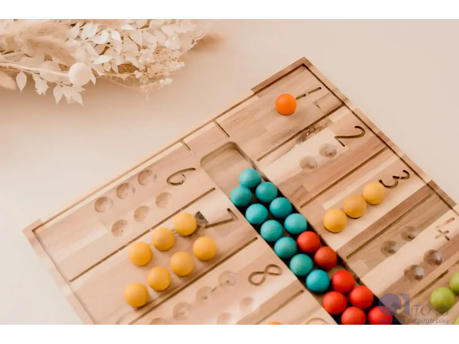 Wooden counting board with colorful beads arranged in rows.