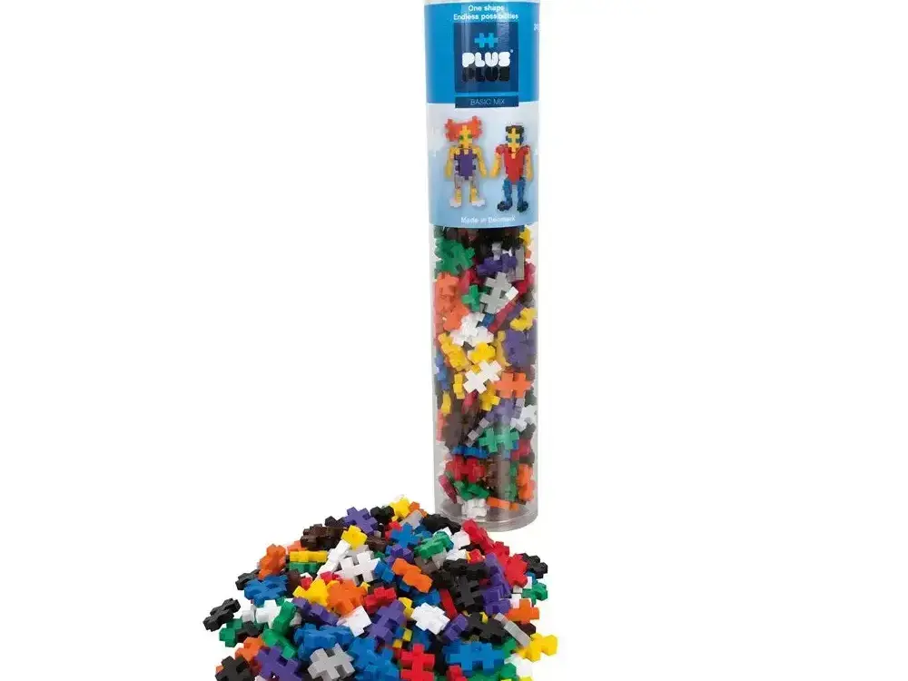 Cylindrical tube filled with colorful plastic building blocks spilling out at the bottom.