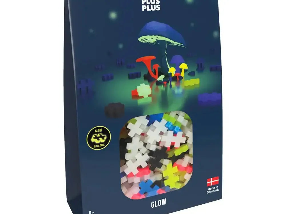 Box of colorful glow-in-the-dark building blocks featuring a mushroom scene on the packaging.