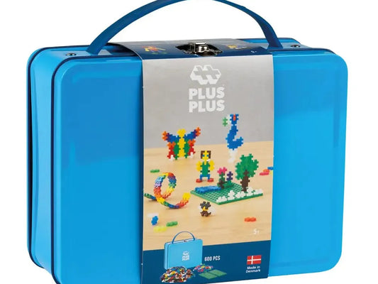 Blue metal lunchbox-style container with a handle and a colorful label showing toy building blocks.
