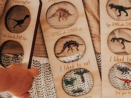 Wooden dinosaur-themed bookmarks with carved silhouettes and fun facts.
