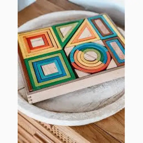Colorful wooden geometric shape puzzle or toy set in a tray.
