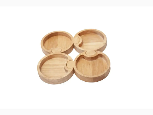 Set of four interconnected wooden coasters with circular indentations.