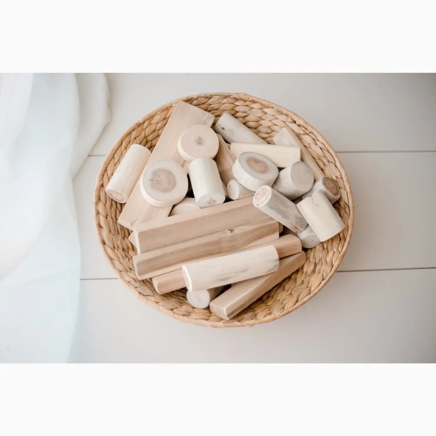 Wicker basket filled with wooden blocks.