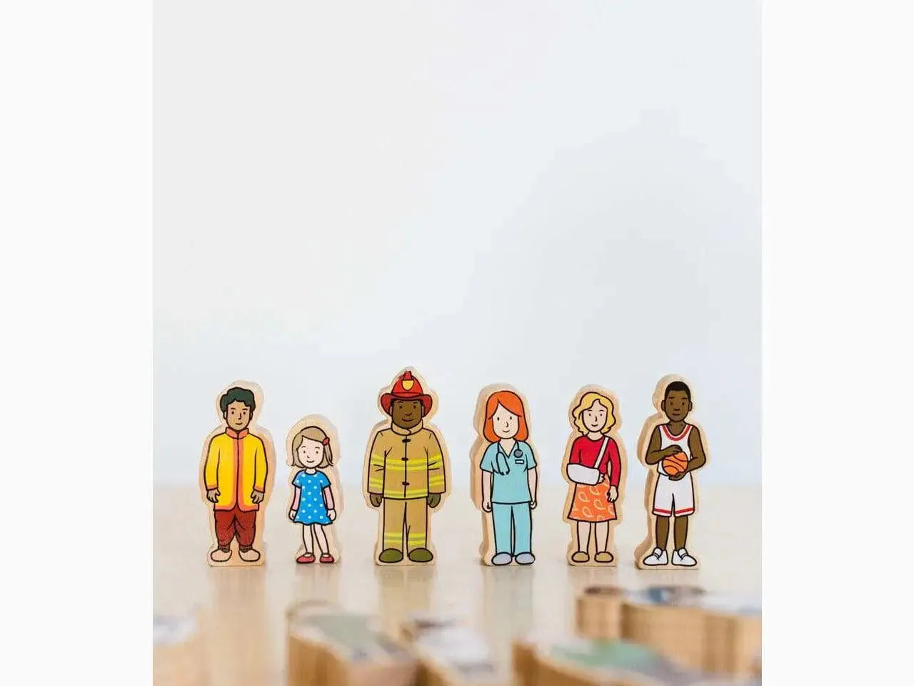 Six diverse wooden toy figures representing different occupations and ethnicities.
