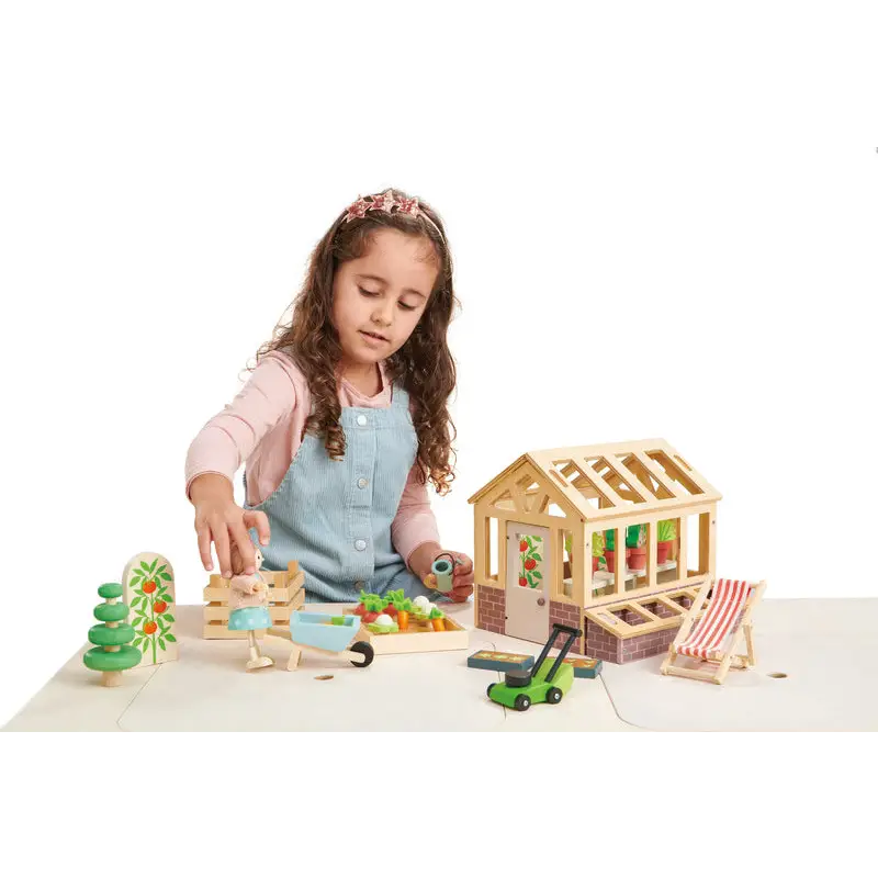 Wooden toy greenhouse and garden set.