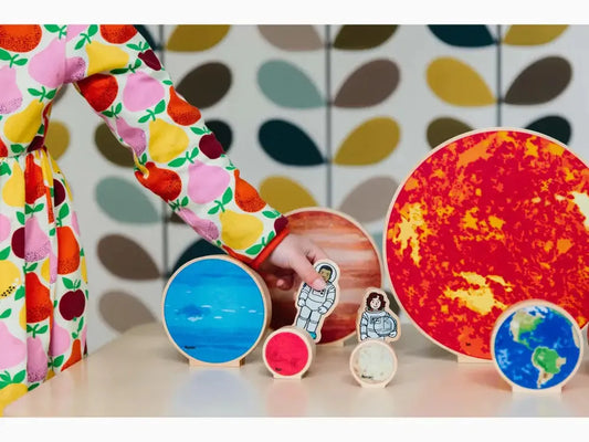 Colorful collection of planet and space-themed objects arranged on a surface.