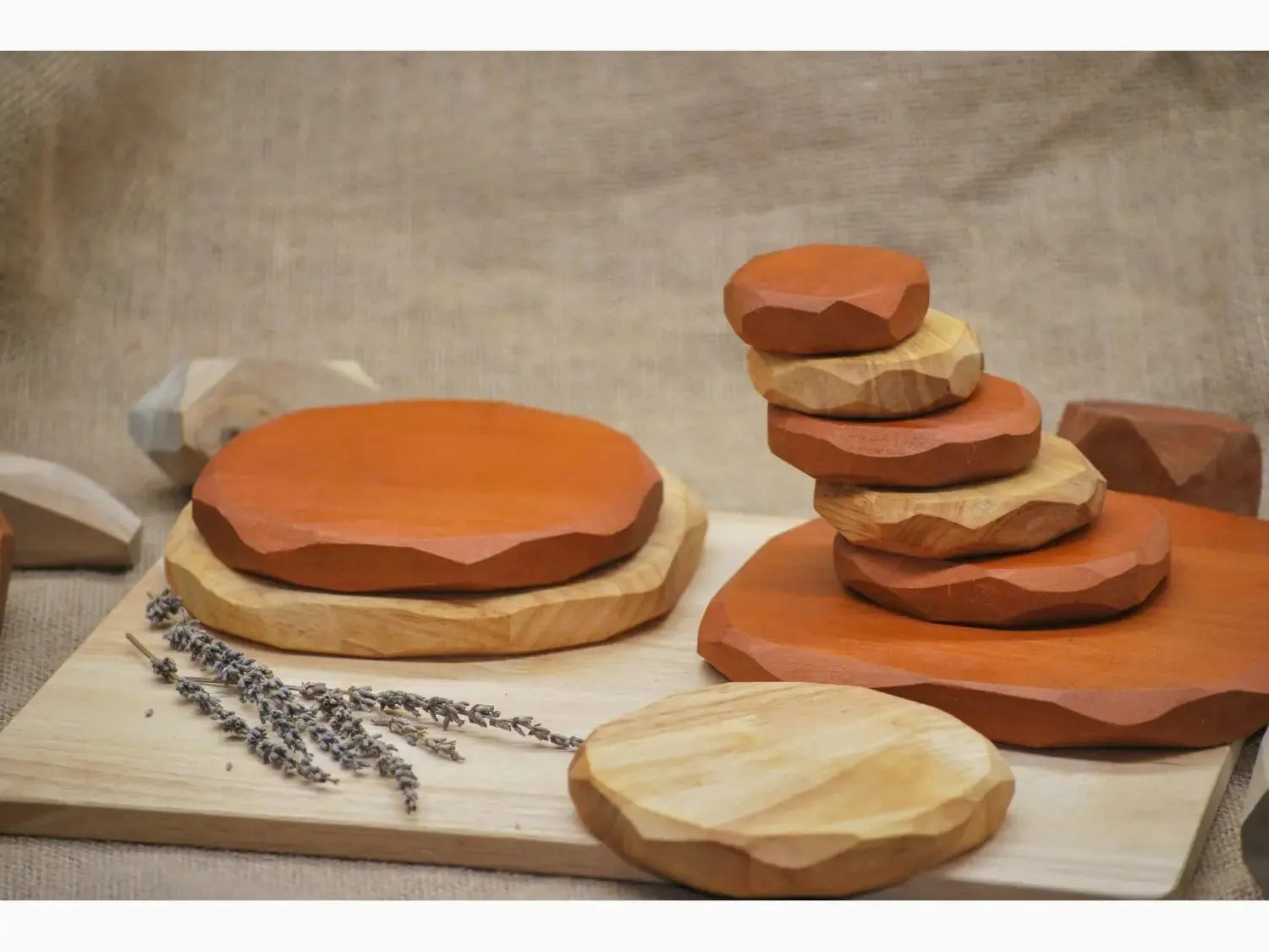 Clay pottery pieces in various shapes and sizes arranged on a wooden board.