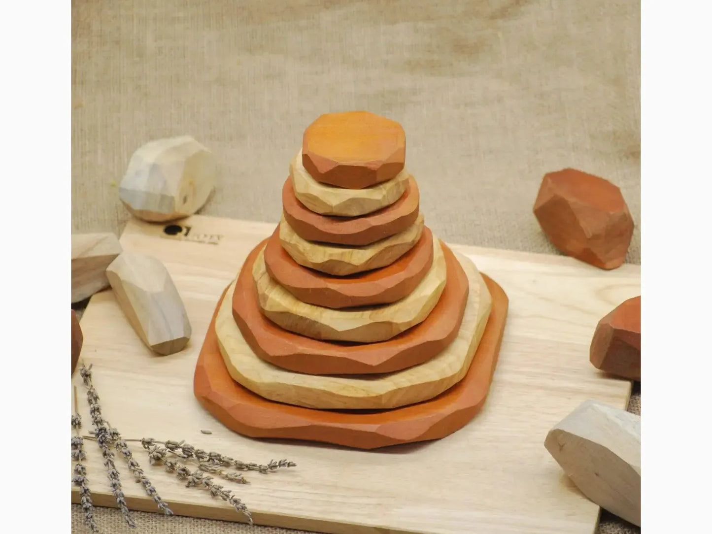 Stacked wooden discs forming a pyramid-like shape on a cutting board.