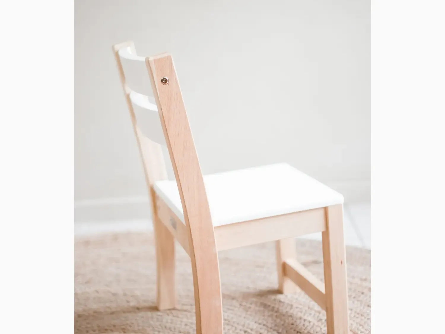 Wooden chair with white seat.