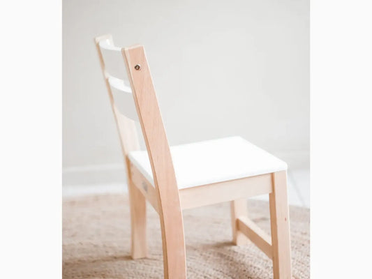 Wooden chair with white seat.