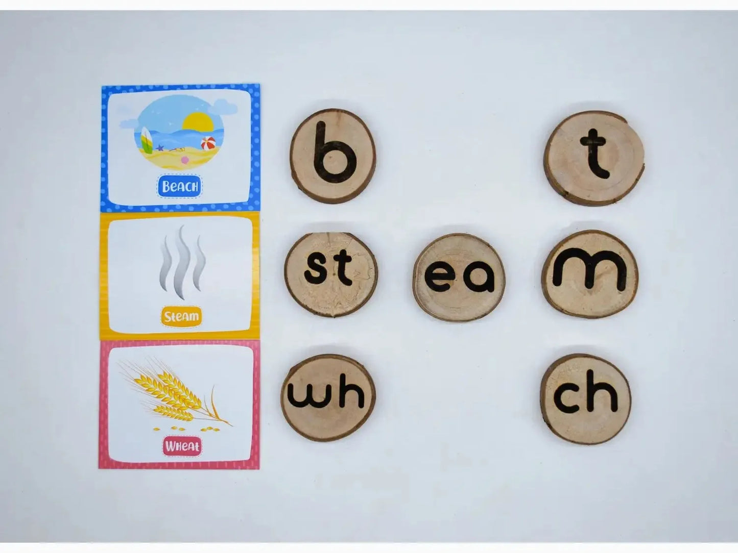 Educational materials featuring phonics word tiles and picture cards for teaching reading and language skills.