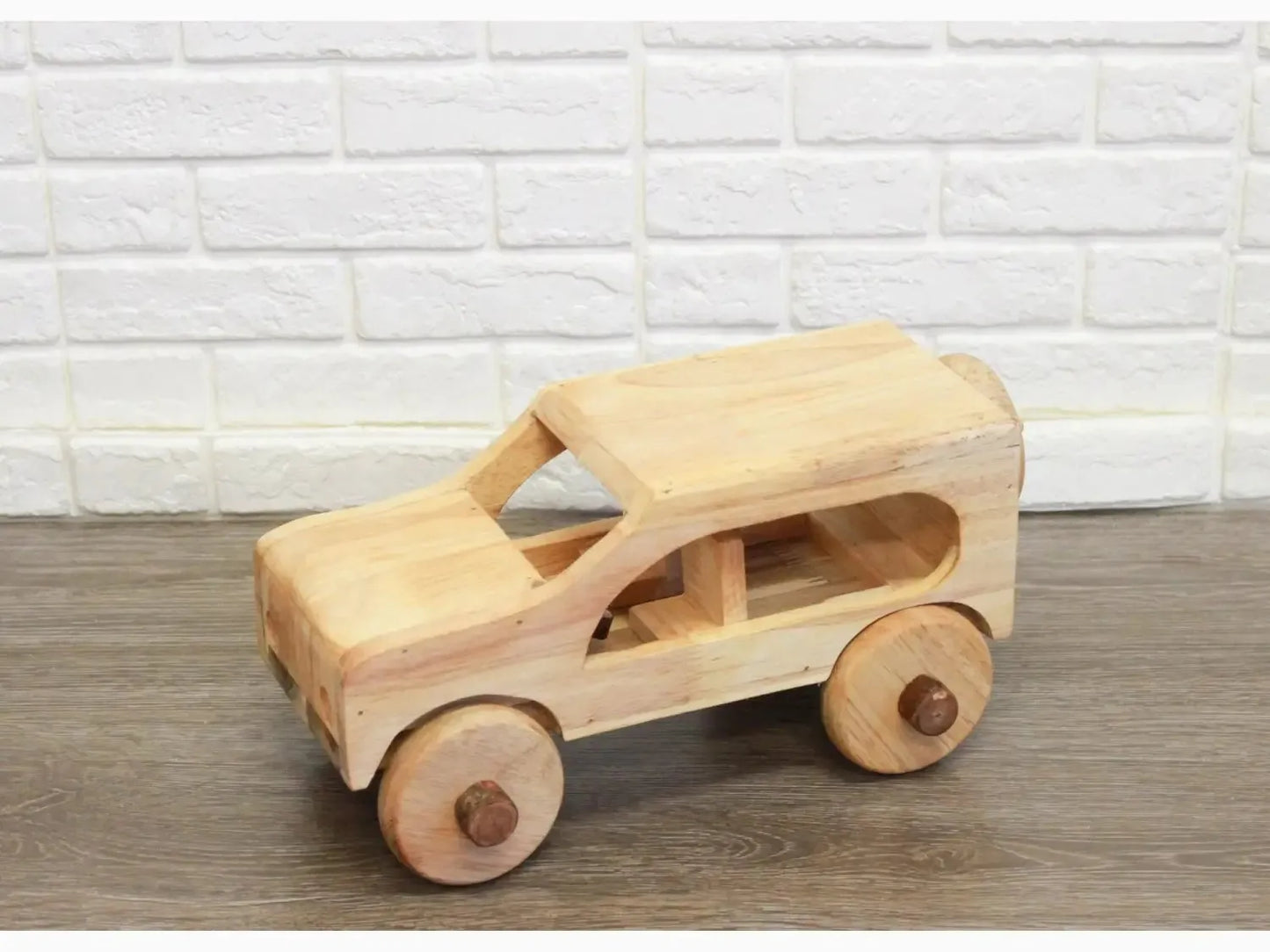 Wooden toy car with rounded edges and circular wheels.