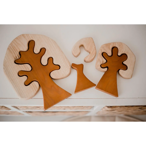 Wooden puzzle pieces shaped like abstract trees or mushrooms.