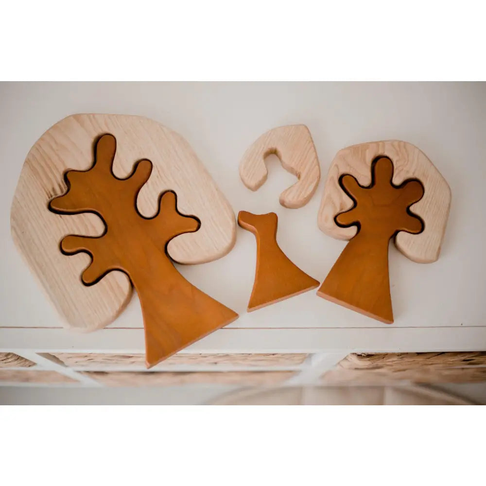 Wooden puzzle pieces shaped like abstract trees or mushrooms.