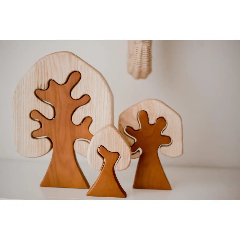 Wooden tree-shaped decorative objects with curved branches.