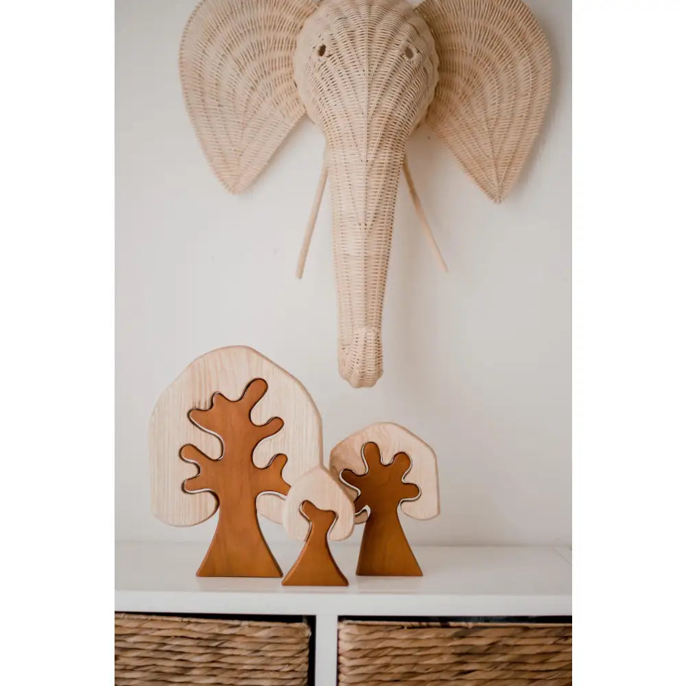 Woven elephant head wall decoration with large ears and trunk.